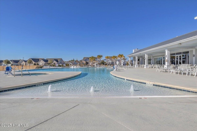 view of pool with pool water feature and a patio