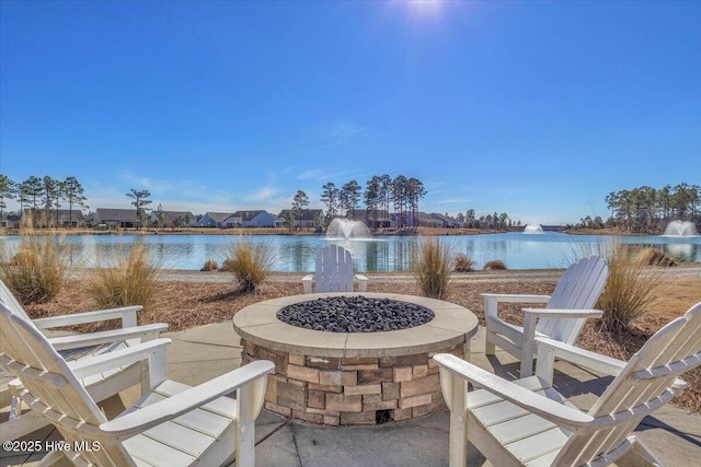 view of patio / terrace featuring a water view and an outdoor fire pit