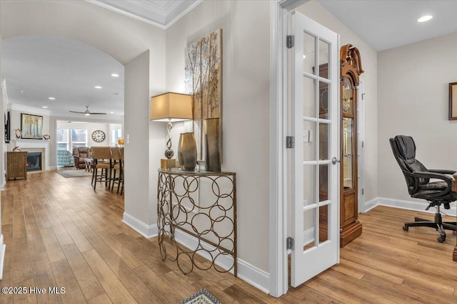 hall with crown molding and light wood-type flooring