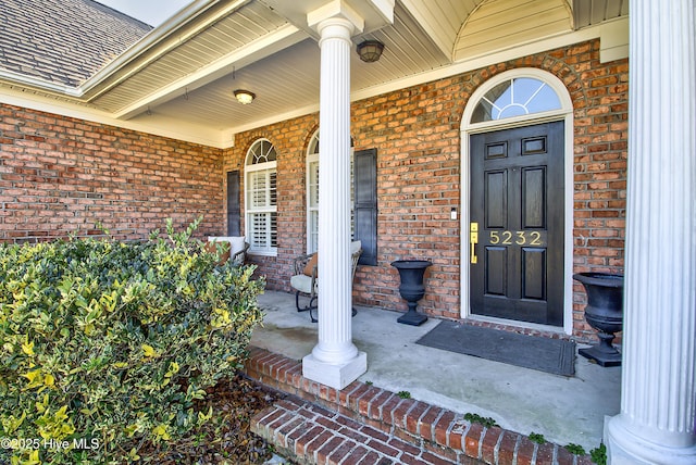 view of exterior entry featuring a porch