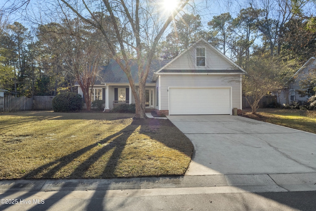 view of front of property featuring a garage and a front yard