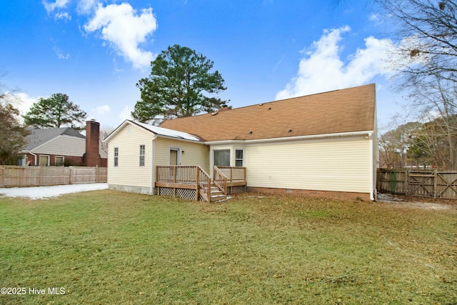 back of property with a deck, crawl space, a lawn, and fence