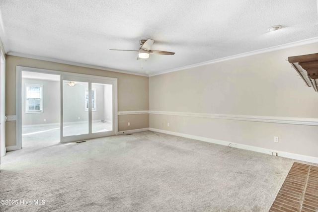 carpeted empty room featuring baseboards, a textured ceiling, ornamental molding, and a ceiling fan