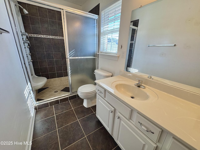 bathroom with vanity, walk in shower, tile patterned floors, and toilet