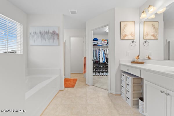 bathroom with vanity and a bathtub