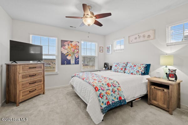 bedroom featuring ceiling fan and light colored carpet