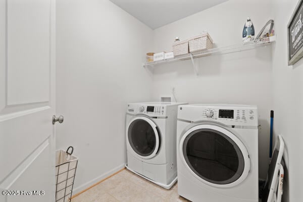 clothes washing area with washing machine and clothes dryer