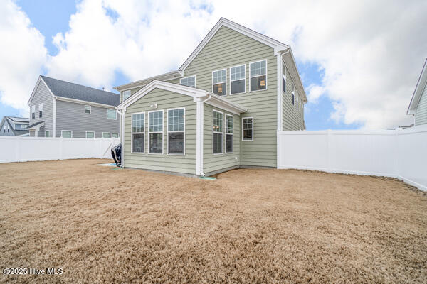 back of house with a lawn