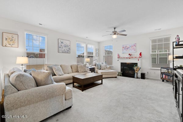 carpeted living room featuring ceiling fan