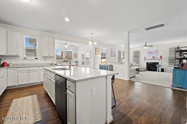 kitchen with sink, white cabinetry, dark hardwood / wood-style flooring, dishwasher, and a kitchen island with sink