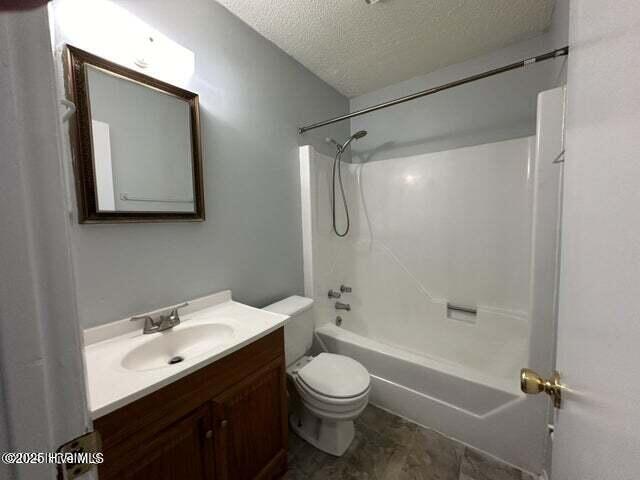 full bathroom with toilet, vanity, bathtub / shower combination, and a textured ceiling