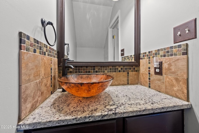 bathroom featuring tasteful backsplash and vanity