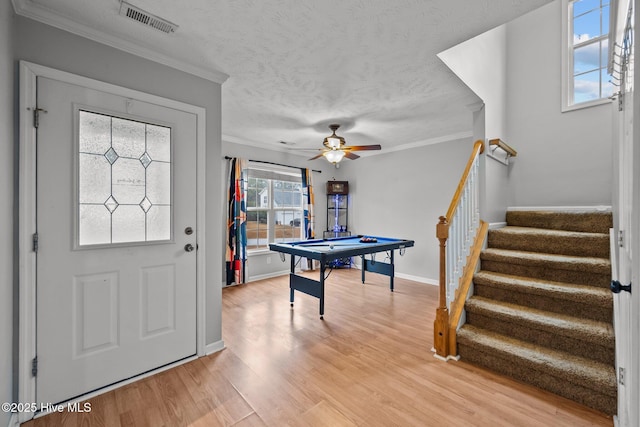 rec room with pool table, ornamental molding, hardwood / wood-style floors, and a textured ceiling