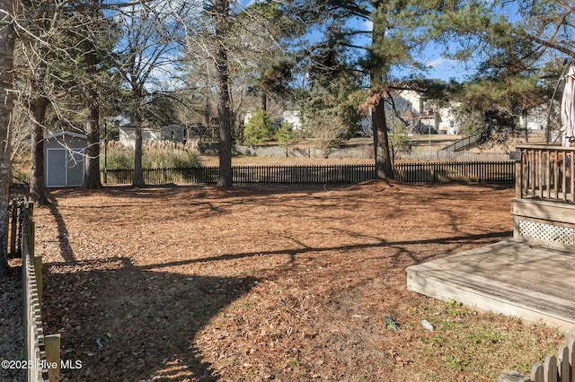 view of yard with a storage unit and a deck