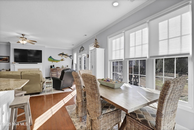 dining area with crown molding, hardwood / wood-style floors, and ceiling fan