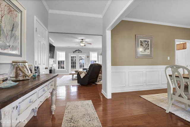 interior space with crown molding, dark wood-type flooring, and ceiling fan