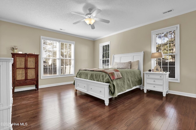 bedroom with ornamental molding, dark wood-type flooring, ceiling fan, and a textured ceiling