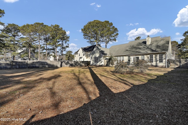 rear view of house featuring a yard