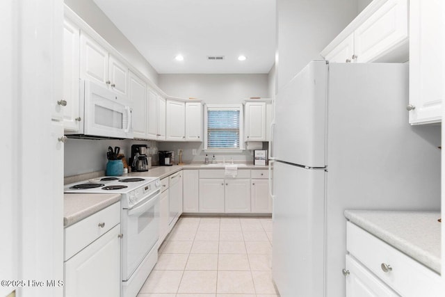 kitchen featuring sink, white appliances, white cabinets, and light tile patterned flooring