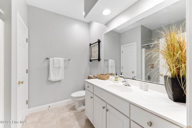 bathroom featuring tile patterned floors, vanity, and toilet