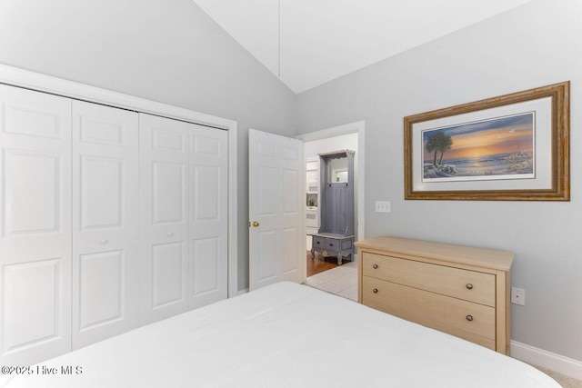 bedroom featuring vaulted ceiling and a closet