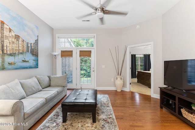 living room with hardwood / wood-style flooring and ceiling fan