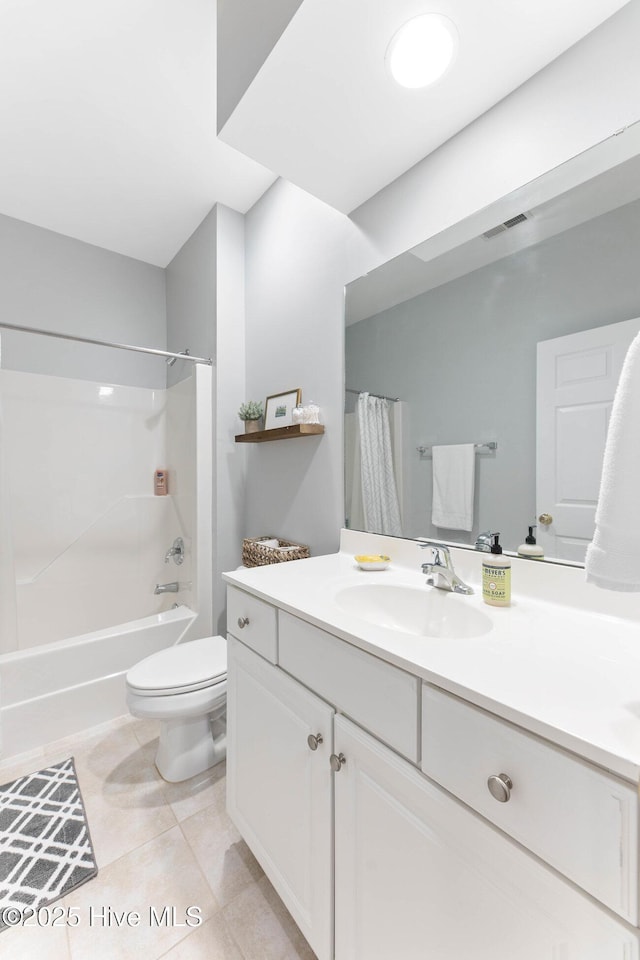 full bathroom with tile patterned floors, toilet, shower / bath combo with shower curtain, and vanity