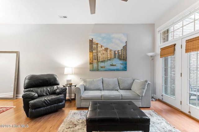 living room with ceiling fan and light hardwood / wood-style floors