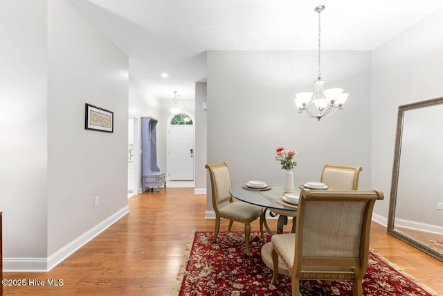 dining room featuring an inviting chandelier and light wood-type flooring