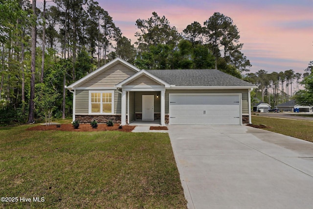 view of front of house with a garage, stone siding, driveway, and a front yard