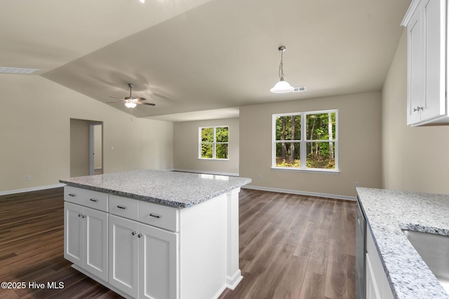 kitchen featuring white cabinets, a ceiling fan, open floor plan, and dark wood-style flooring