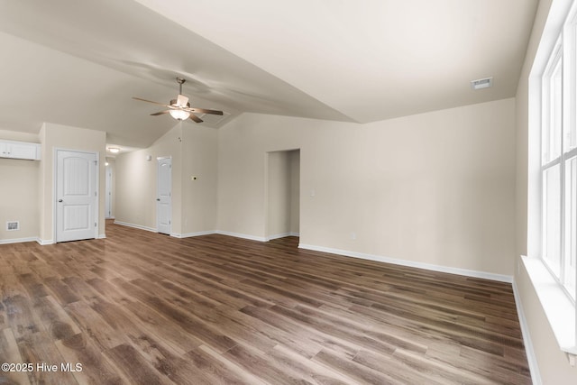 unfurnished living room with lofted ceiling, visible vents, ceiling fan, baseboards, and wood finished floors