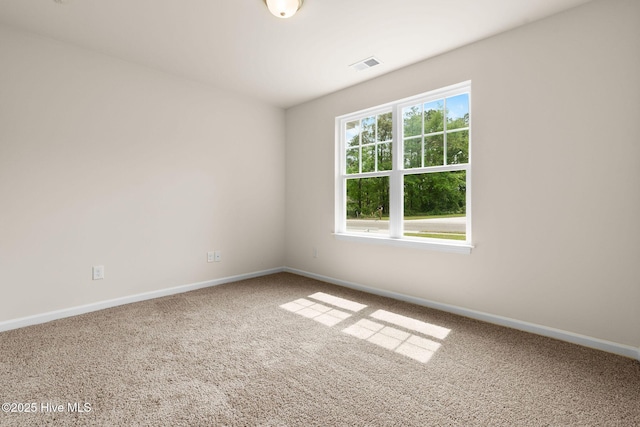 unfurnished room featuring baseboards, visible vents, and carpet flooring