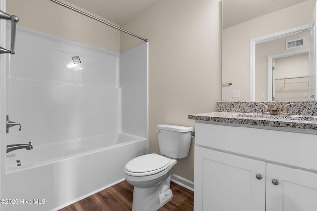 full bath featuring visible vents, tub / shower combination, toilet, wood finished floors, and vanity