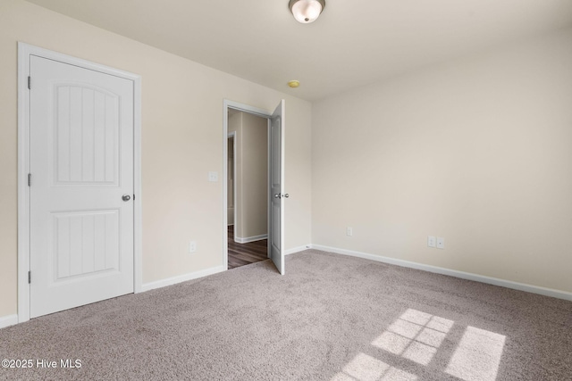 unfurnished bedroom featuring baseboards and carpet floors