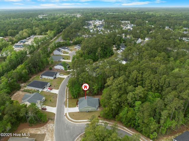 aerial view with a wooded view and a residential view