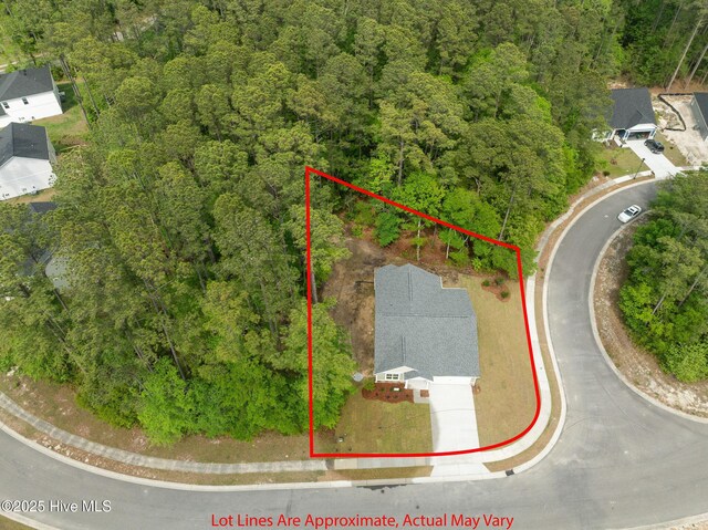 birds eye view of property with a wooded view