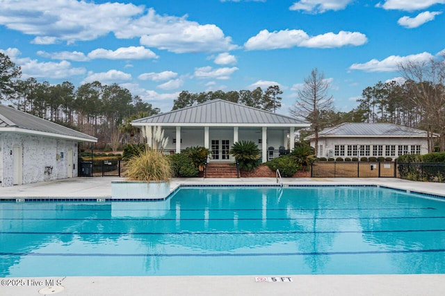 pool featuring fence, a patio, and french doors