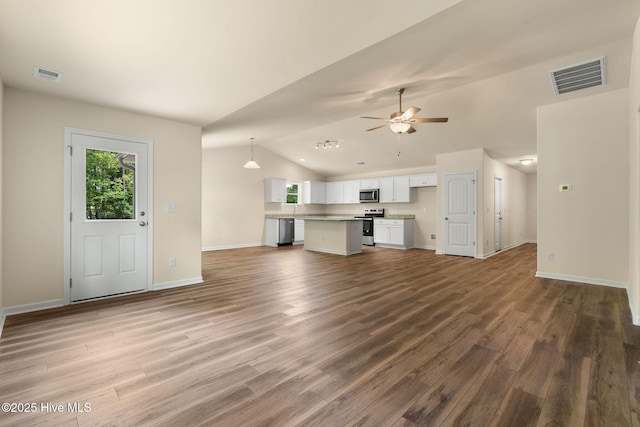 unfurnished living room with lofted ceiling, wood finished floors, visible vents, and baseboards