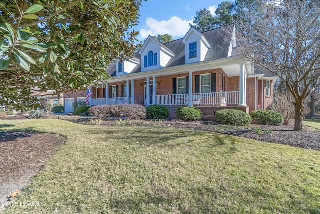 cape cod home featuring a porch and a front lawn