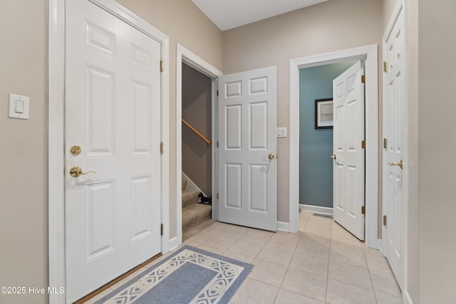 hall with light tile patterned floors