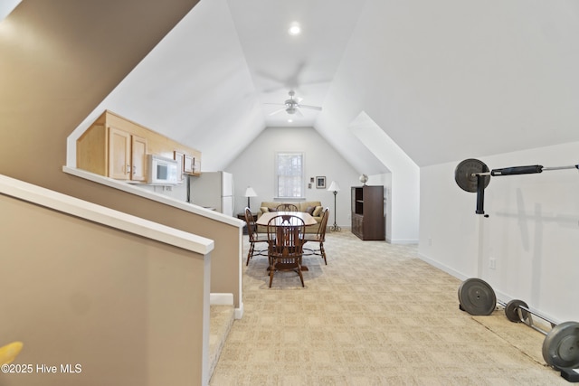 exercise area featuring lofted ceiling, light colored carpet, and ceiling fan