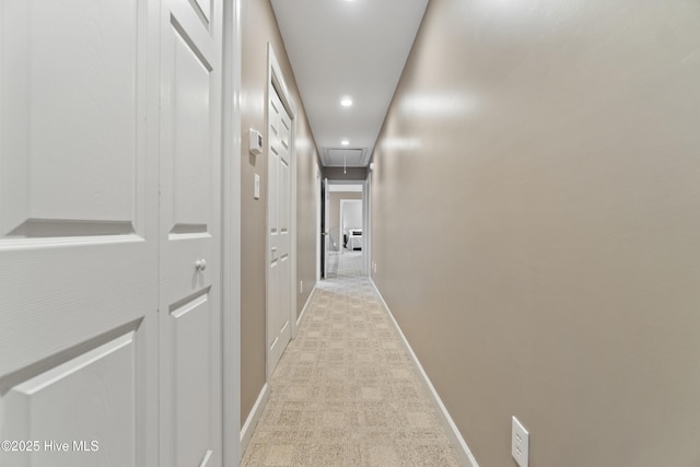 hall featuring light colored carpet