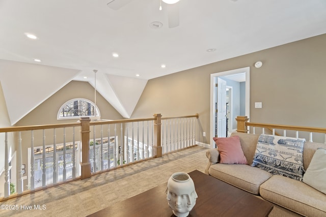 living room featuring lofted ceiling, ceiling fan, and carpet flooring