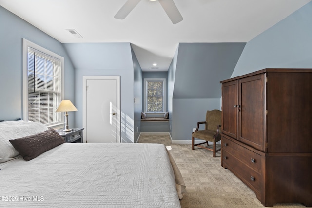 bedroom with ceiling fan, vaulted ceiling, and light carpet