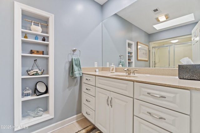 bathroom featuring vanity, tile patterned floors, built in features, and a shower with door