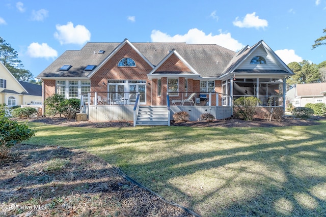 view of front of home with a sunroom and a front yard