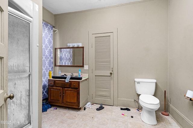 bathroom with vanity, crown molding, a shower, and toilet