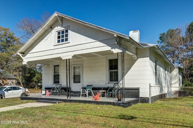 view of front of property with covered porch and a front yard