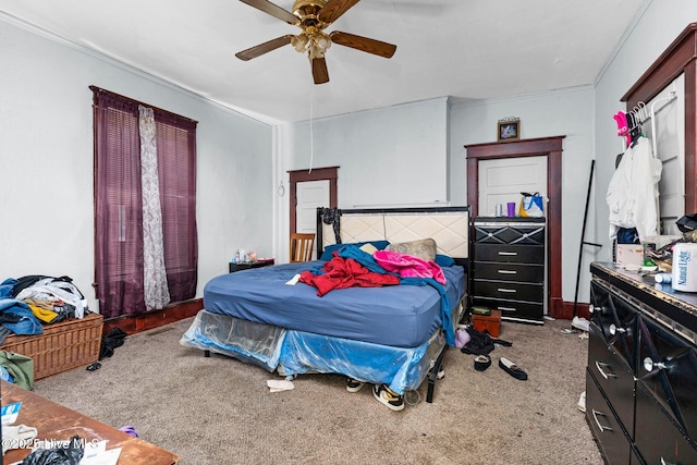 bedroom with crown molding, ceiling fan, and light carpet